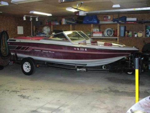 1988 Ford Bronco - A boat is parked on a trailer inside a garage, with shelves and equipment visible in the background.