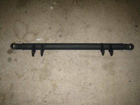 1987 Suzuki Samurai - A black metal suspension bar is shown against a concrete background, with visible mounting points and brackets.