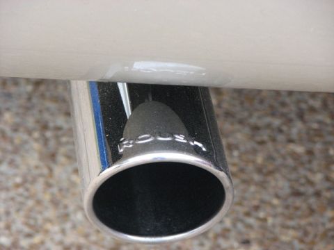 1991 Ford Bronco - Close-up of a vehicle's chrome exhaust pipe displaying the 'ROUSH' branding.