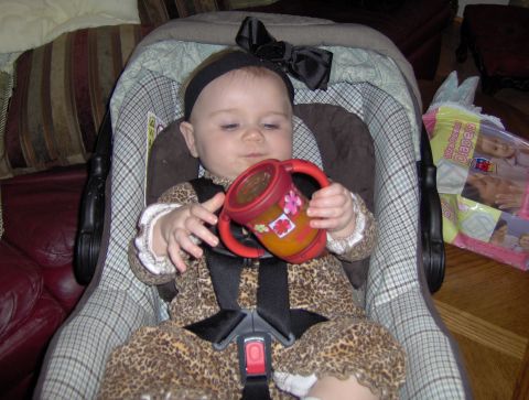 1978 Ford Bronco - A baby sits in a car seat, holding a sippy cup, with a box of diapers in the background.