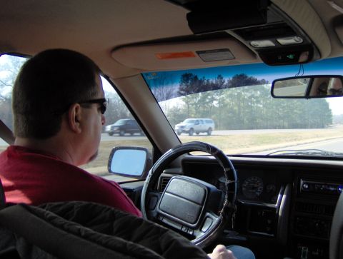 1978 Ford Bronco - View from the driver's seat as the car travels down a highway with another vehicle visible ahead.