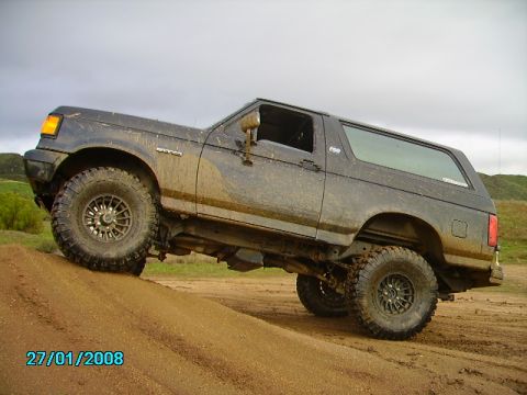 1990 Ford Bronco - This 1990 Ford Bronco is shown off-road, navigating a dirt incline.