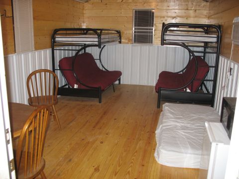 1978 Ford Bronco - This room contains bunk beds with futons and a mattress, suggesting it's a sleeping area.