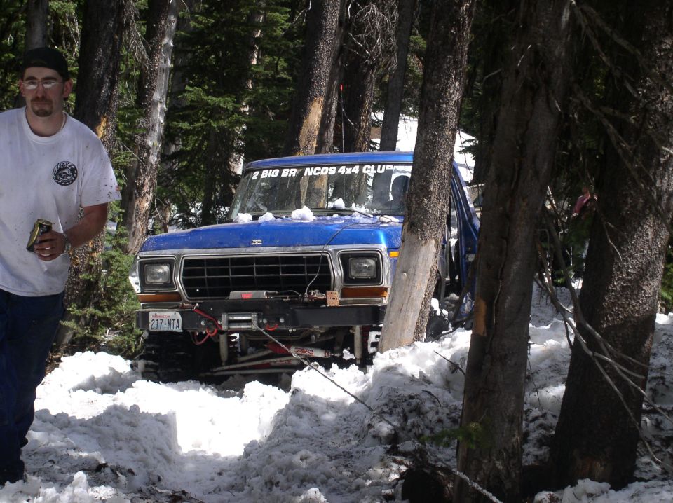Blue 1979 Ford Bronco with winch in snow, front view