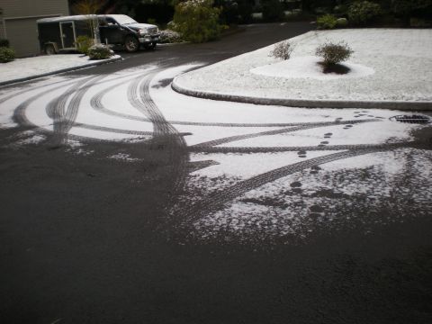 1993 Ford Bronco - Tire tracks mark a snowy driveway where a truck and trailer are parked.