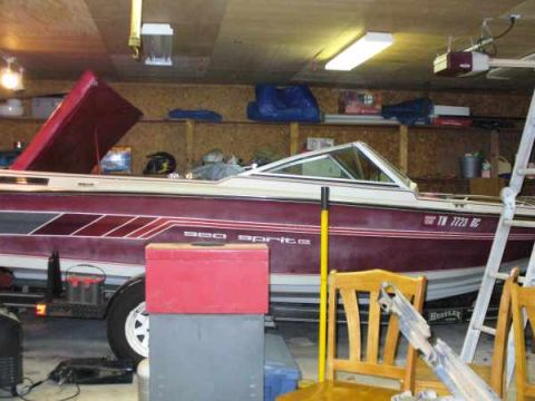 1988 Ford Bronco - A boat is parked inside a garage, with its hood open and a ladder nearby.