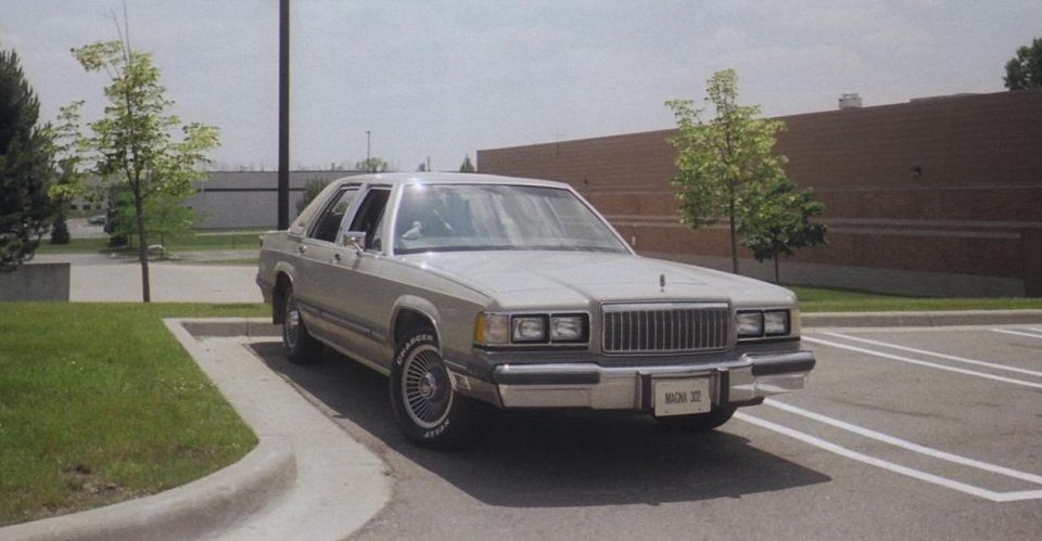 Silver Mercury Grand Marquis sedan parked in a lot