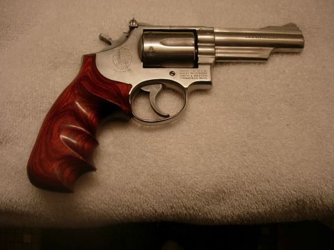 1993 Ford Bronco - A revolver with a stainless steel frame and polished wood grips rests on a textured surface.