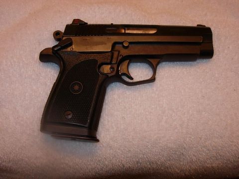 1993 Ford Bronco - A pistol is shown against a textured background.