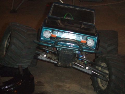 1996 Ford Bronco - This toy monster truck features a teal grille and oversized tires, resembling a classic SUV body.