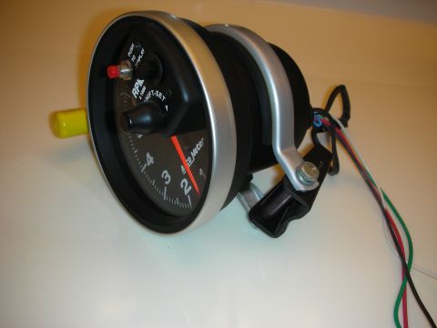 1998 Ford Crown Victoria - Aftermarket pedestal tachometer showing its black RPM dial face with shift-light and adjustment knobs.