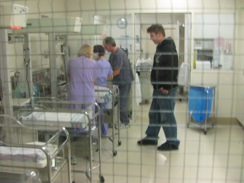 1987 Suzuki Samurai - A hospital nursery scene shows incubators and medical personnel attending to them, with a visitor observing.