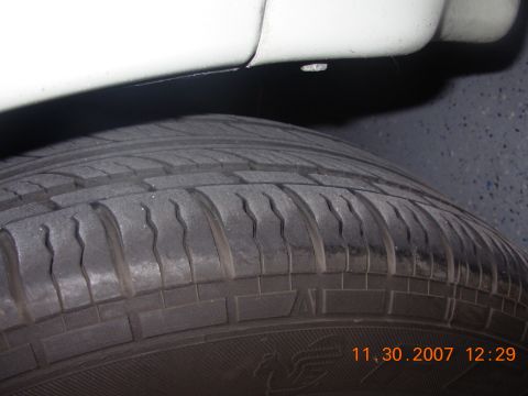 1995 Ford Taurus - A close-up view of a tire and the lower body panel of a vehicle, with a timestamp visible in the corner.