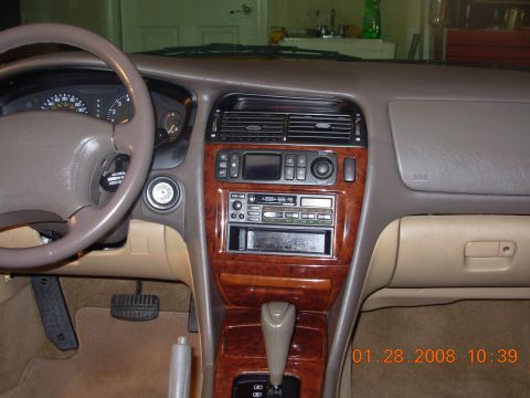 1995 Ford Taurus - Interior view of a car's dashboard, showing the center console and steering wheel.