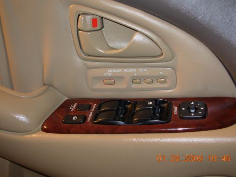 1995 Ford Taurus - Close-up of a car's interior door panel, showing window controls and seat memory settings.