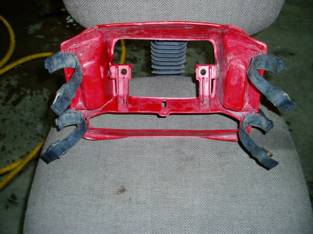 Red plastic part with black straps