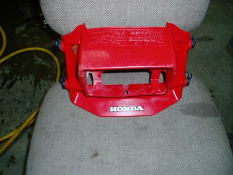 2000 Ford E350 - This is a red plastic part with the HONDA logo, likely from a motorcycle.