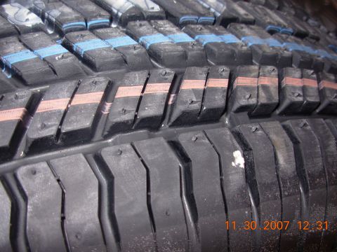 1995 Ford Taurus - A close-up view of a tire's tread pattern, showing the texture and markings on the rubber.