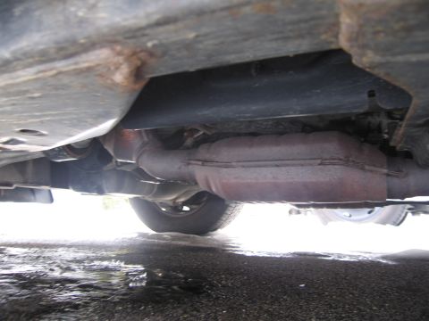1991 Ford LTD Crown Victoria - This photo shows the underside of a vehicle, focusing on the exhaust system and frame components.