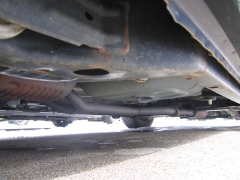 1991 Ford LTD Crown Victoria - The underside of a vehicle is visible, the exhaust system and fuel tank.