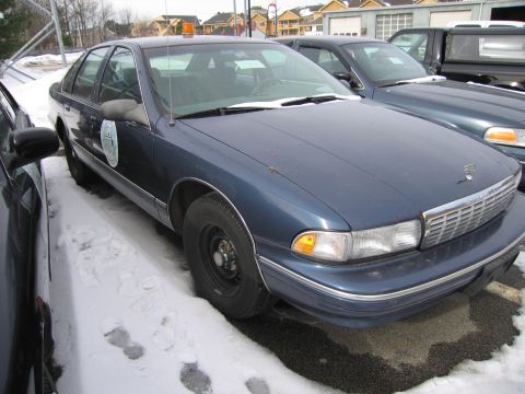 1991 Ford LTD Crown Victoria - This blue sedan, possibly a 1991 model, is parked outdoors in the snow.