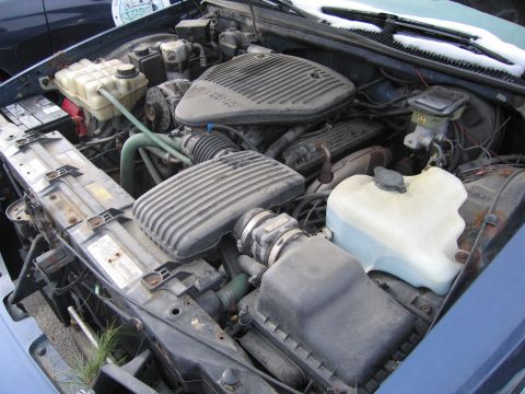 1991 Ford LTD Crown Victoria - Engine bay components including air intake and fluid reservoirs are shown in this photo.