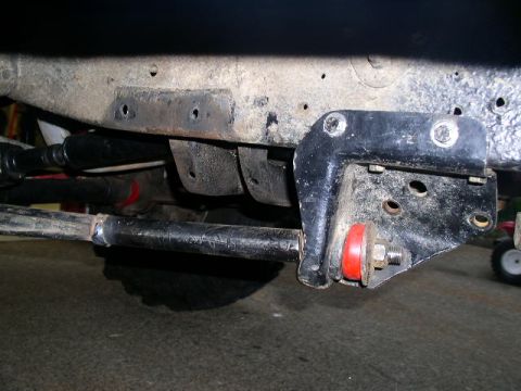 1979 Ford Bronco - This image shows a close-up view of a vehicle's suspension system, focusing on a bracket and bushings.