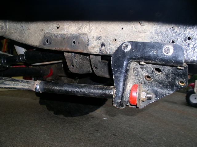 Undercarriage frame bracket with red poly bushing and control arm