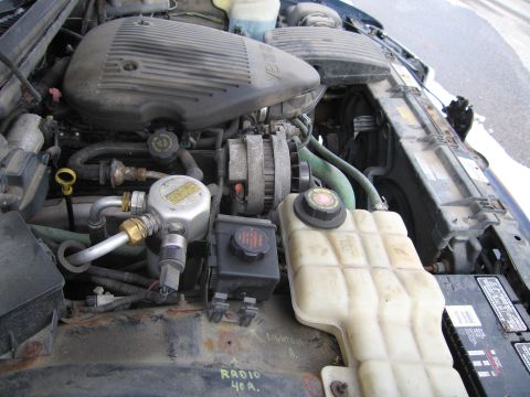 1991 Ford LTD Crown Victoria - The engine bay of a 1991 Ford Crown Victoria LTD is visible, with various engine components and fluids.