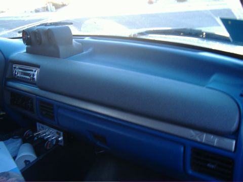 1995 Ford Bronco - Interior view of a 1995 Ford Bronco dashboard, showing aftermarket gauges and stereo system.