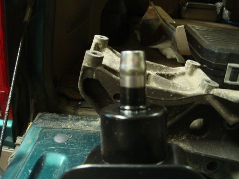 1996 Ford Bronco - A close-up view of a power steering pump shaft and its associated mounting bracket, likely taken during a repair or maintenance procedure.