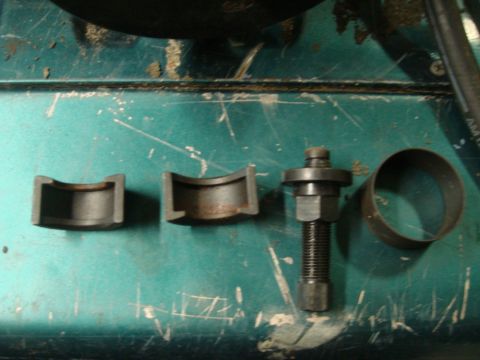 1996 Ford Bronco - A set of automotive tools, including a bearing separator, is laid out on a workbench.