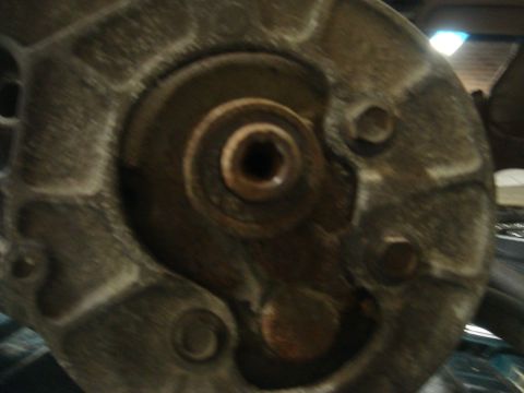 1996 Ford Bronco - A detailed view of a mechanical component, likely an engine part, showing its metallic texture and bolted construction.
