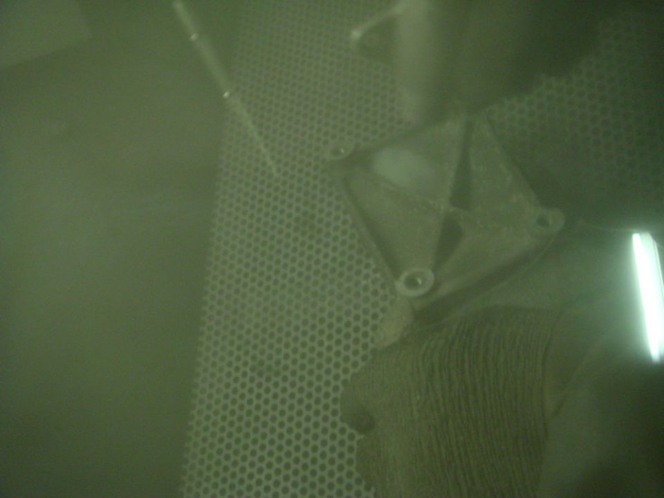metal bracket with bolts on a perforated surface