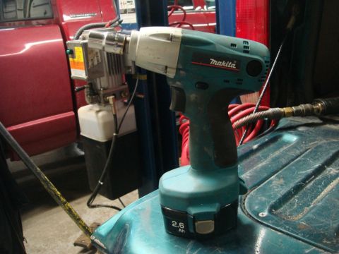 1996 Ford Bronco - A Makita impact wrench and a hydraulic pump are shown in a workshop setting.