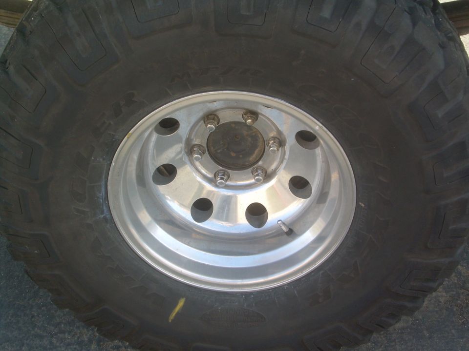 Close-up of a large off-road tire mounted on a silver alloy wheel