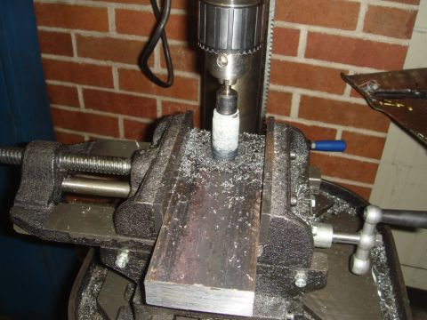 1996 Ford Bronco - Drill press setup with a hole saw cutting into metal stock held by a vise.