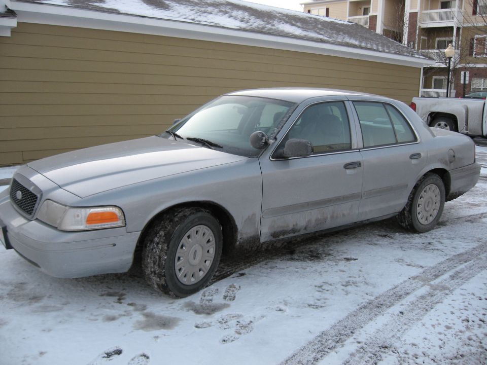Silver 2004 Ford Crown Victoria sedan in snow