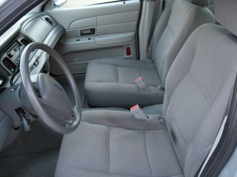 2004 Ford Crown Victoria - Interior view of a 2004 Ford Crown Victoria, highlighting the front seating area and controls.