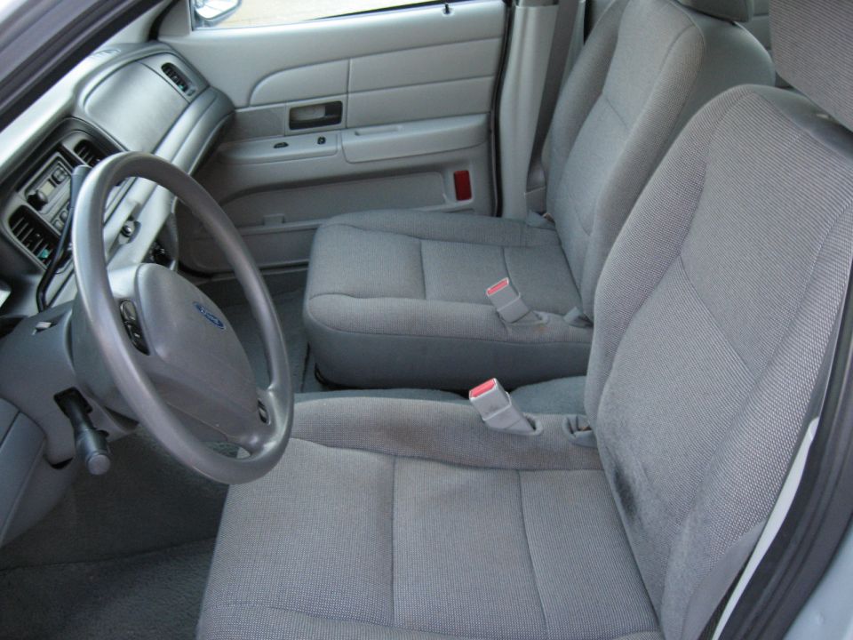 2004 Ford Crown Victoria interior showing front seats, steering wheel, and dashboard