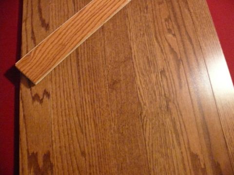1988 Ford Bronco - Wood flooring with a red border and a wooden trim piece is visible.