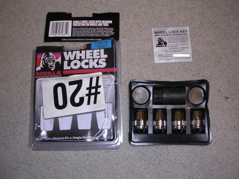 1983 Ferrari Enzo - Package of Gorilla Wheel Locks, including the key and four lug nuts, is displayed on a carpeted surface.