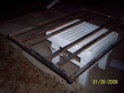 1984 Toyota 4Runner - A metal rack structure is supported by sawhorses on a concrete surface.