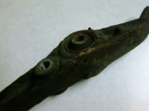 1995 Ford Bronco - A heavily rusted suspension component is shown against a plain background.