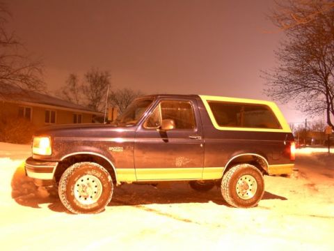 1994 Ford Bronco - A 1994 Ford Bronco is seen parked in the snow at night.