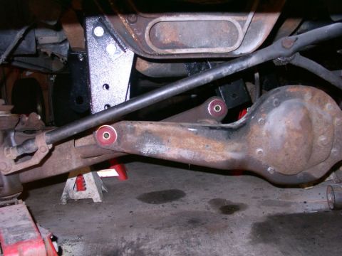 1994 Ford Bronco - Undercarriage view of suspension components, possibly during a lift installation, with a Supermotors.net watermark.