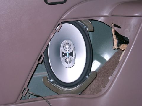 1994 Ford Bronco - Aftermarket speaker installed in a car door panel, showing the interior of the vehicle.