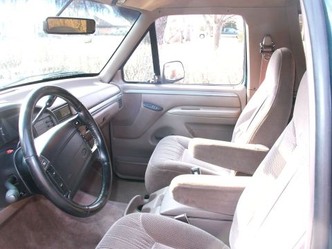 1994 Ford Bronco - Interior view of a 1994 Ford Bronco, highlighting the front seating area and dashboard.