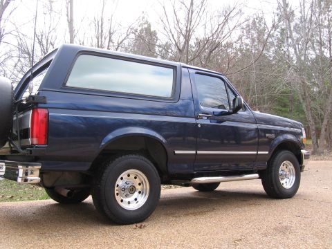 1967 Ford Mustang - This blue Ford Bronco is shown from the rear three-quarter angle, with a spare tire on the back.