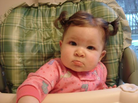 2000 Ford Crown Victoria - A baby sits in a high chair, looking unimpressed.